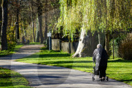 Elderly Woman With A Rollator Walking Outdoors