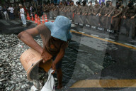 Protesters Dump Blackchin Tilapia In Front Of Police