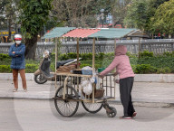 Street Vendor Selling Local Goods In Vietnam