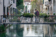 Romantic Embrace On A Picturesque Bridge In Treviso