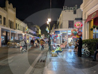 Hanoi Street Vendor Under Neon Lights