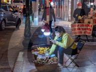 Hanoi Street Vendor Under Neon Lights