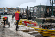 DHL Boat Parcel Delivery At A Canal Dock In Venice