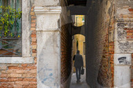 Businessman Walking Through Narrow Venetian Alley