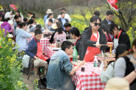 Tourists Eat Hot Pot Among Blooming Rapeseed Flowers in Nanjing