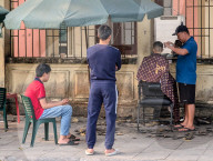 Sidewalk Barber In Vietnam