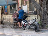 Sidewalk Barber In Vietnam