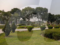 Elderly Men Resting On A Bench In A City Park In Vietnam