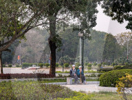 Elderly Men Resting On A Bench In A City Park In Vietnam
