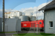 An Austrian Federal Railways Locomotive Near Industrial Tanks In Braunau Am Inn