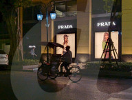 Cyclo Passing By Prada Store In Hanoi