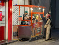 Customers Buy Drinks At A Street Cart In Hanoi
