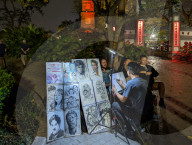 Street Artist Sketches Portraits Near Ngoc Son Temple In Hanoi