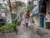 Woman Carries Food Using A Shoulder Pole In Hanoi