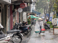 Woman Carries Food Using A Shoulder Pole In Hanoi