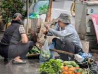 Street Vendor Sells Vegetables In Hanoi