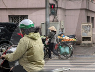 Street Vendor Pushes Fruit Bicycle In Hanoi