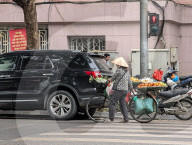 Street Vendor Pushes Fruit Bicycle In Hanoi