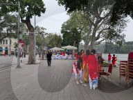 Women In Traditional Dresses At Hoan Kiem Lake In Hanoi