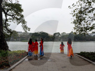 Women In Traditional Dresses At Hoan Kiem Lake In Hanoi