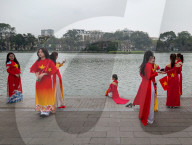 Women In Traditional Dresses At Hoan Kiem Lake In Hanoi