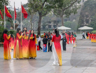 Women In Traditional Dresses At Hoan Kiem Lake In Hanoi