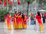 Women In Traditional Dresses At Hoan Kiem Lake In Hanoi