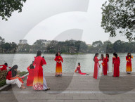 Women In Traditional Dresses At Hoan Kiem Lake In Hanoi