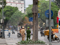 Police Officers Monitor Street Activity At Le Thanh Tong Intersection In Hanoi