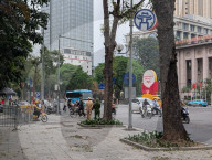 Police Officers Monitor Street Activity At Le Thanh Tong Intersection In Hanoi