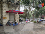 Diners Sit On Plastic Stools In Hanoi