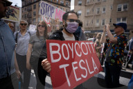 Activists Gather At NYC AIDS Memorial And March To Tesla Dealership For 38th Anniversary Of ACT UP To Protest DOGE Cuts