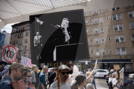 Activists Gather At NYC AIDS Memorial And March To Tesla Dealership For 38th Anniversary Of ACT UP To Protest DOGE Cuts