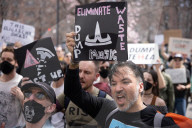 Activists Gather At NYC AIDS Memorial And March To Tesla Dealership For 38th Anniversary Of ACT UP To Protest DOGE Cuts