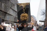 Activists Gather At NYC AIDS Memorial And March To Tesla Dealership For 38th Anniversary Of ACT UP To Protest DOGE Cuts