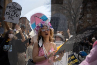 Activists Gather At NYC AIDS Memorial And March To Tesla Dealership For 38th Anniversary Of ACT UP To Protest DOGE Cuts