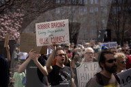 Activists Gather At NYC AIDS Memorial And March To Tesla Dealership For 38th Anniversary Of ACT UP To Protest DOGE Cuts