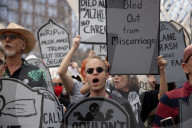Activists Gather At NYC AIDS Memorial And March To Tesla Dealership For 38th Anniversary Of ACT UP To Protest DOGE Cuts