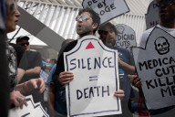 Activists Gather At NYC AIDS Memorial And March To Tesla Dealership For 38th Anniversary Of ACT UP To Protest DOGE Cuts