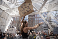 Activists Gather At NYC AIDS Memorial And March To Tesla Dealership For 38th Anniversary Of ACT UP To Protest DOGE Cuts