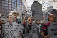 Activists Gather At NYC AIDS Memorial And March To Tesla Dealership For 38th Anniversary Of ACT UP To Protest DOGE Cuts