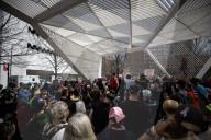 Activists Gather At NYC AIDS Memorial And March To Tesla Dealership For 38th Anniversary Of ACT UP To Protest DOGE Cuts