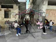 Gaza children playing amidst tents and rubble