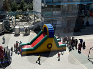 Gaza children playing amidst tents and rubble