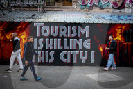  Anti-Tourism Graffiti In Barcelona Draws Tourists Despite Local Discontent
