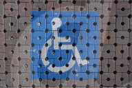 Accessible Parking Symbol On Tactile Pavement In Italy