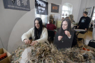 Ukrainian volunteers weave camouflage nets for soldiers