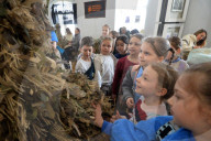 Ukrainian volunteers weave camouflage nets for soldiers