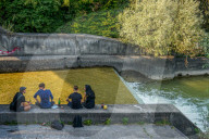 Group Of Friends By Urban Stream