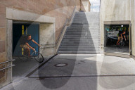 Cyclist Rides Through The Mirrored Interior Of A Tunnel